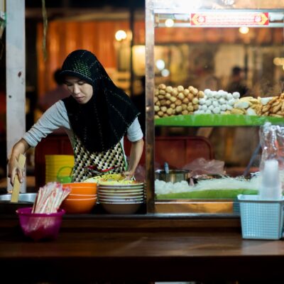 A woman runs a halal food stall in Bangkok.