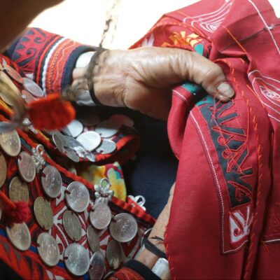 A close-up of the hands of an Oma creating traditional clothing. 5 January 2021. Used with permission of the Traditional Arts and Ethnology Centre, Laos.