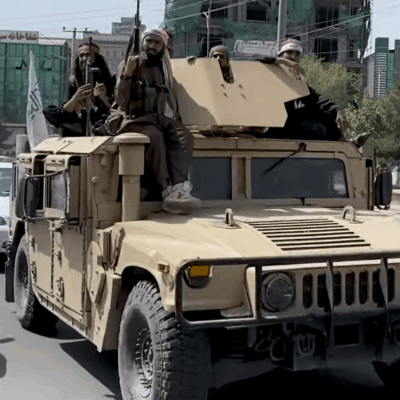 A Taliban Humvee carrying armed men in Kabul street, Afghanistan, August 2021.